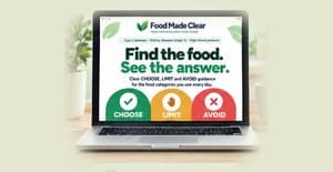 The printed Food Made Clear guide standing among green leaves